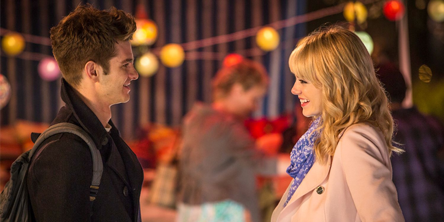 Emma Stone and Andrew Garfield look at each other at a carnival in The Amazing Spider-Man 2