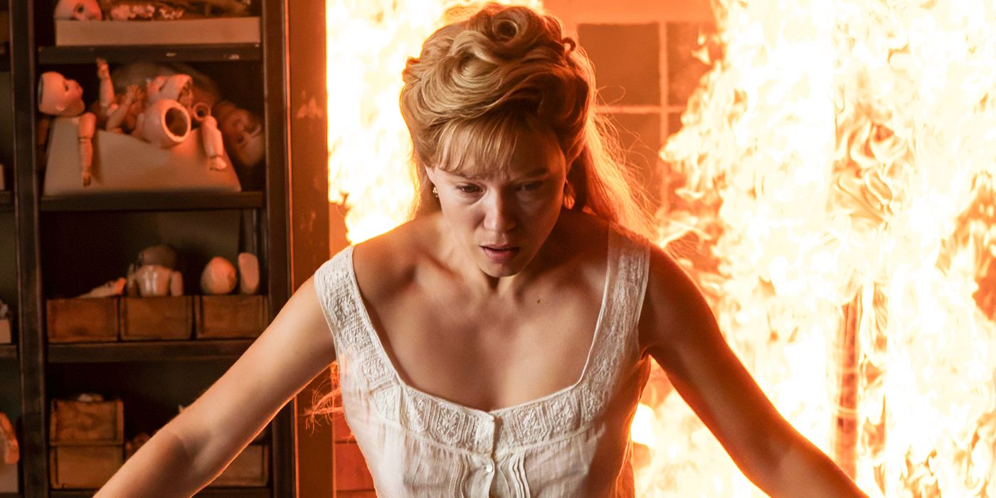 Léa Seydoux standing in front of flames in The Beast. 