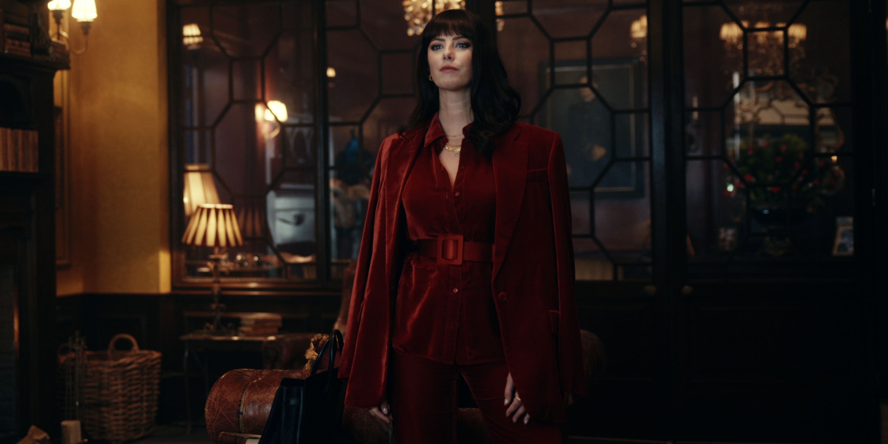 Kaya Scodelario as Susie Glass in a red velvet suit in Episode 3 of The Gentlemen