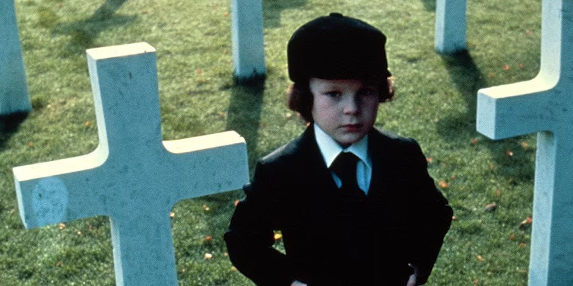 Damien in a graveyard in The Omen 1976