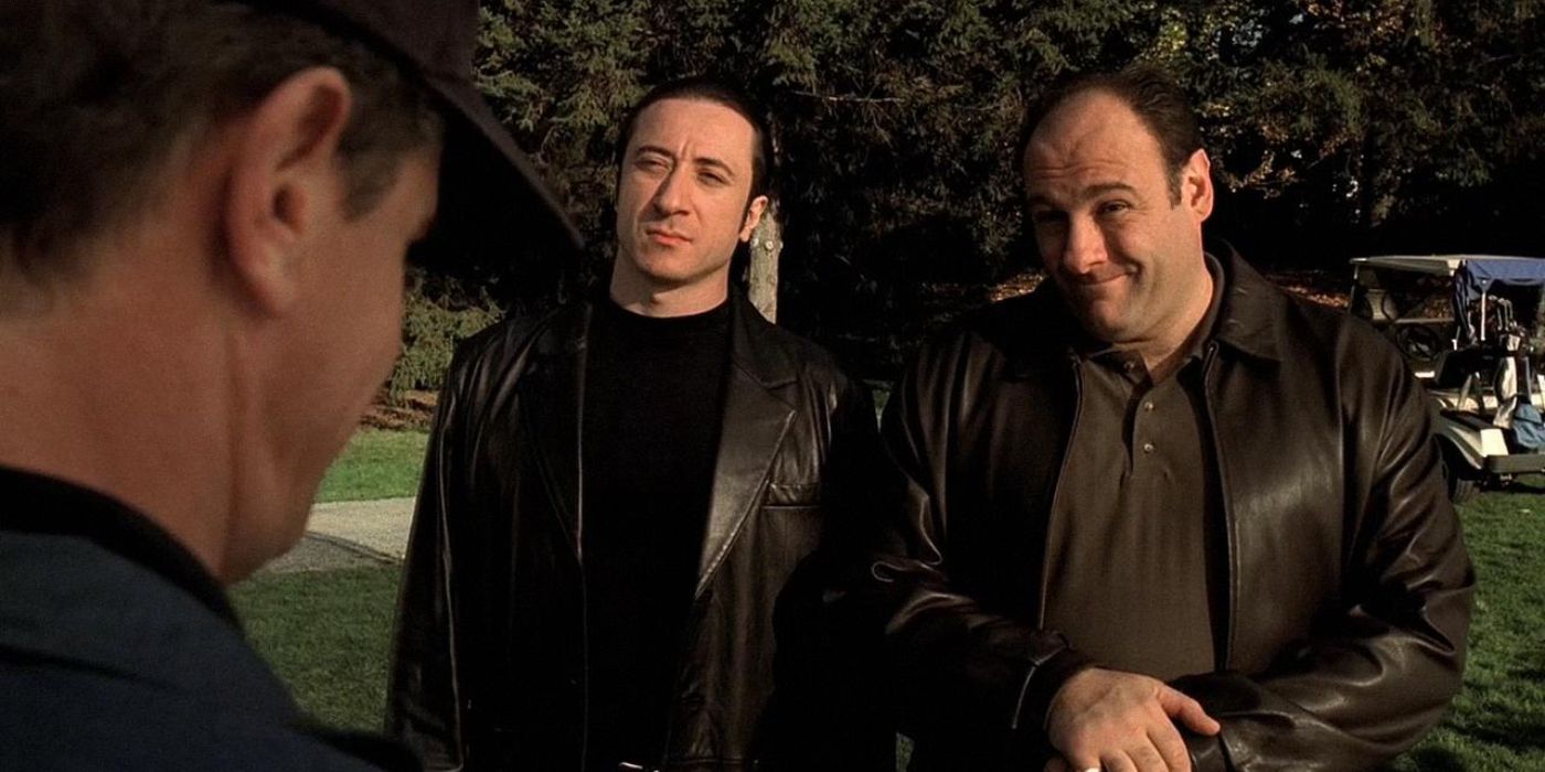 Furio Giunta (Federico Castelluccio) and Tony Soprano (James Gandolfini) stand on a gold course in black leather jackets intimidating someone in 'The Sopranos'.