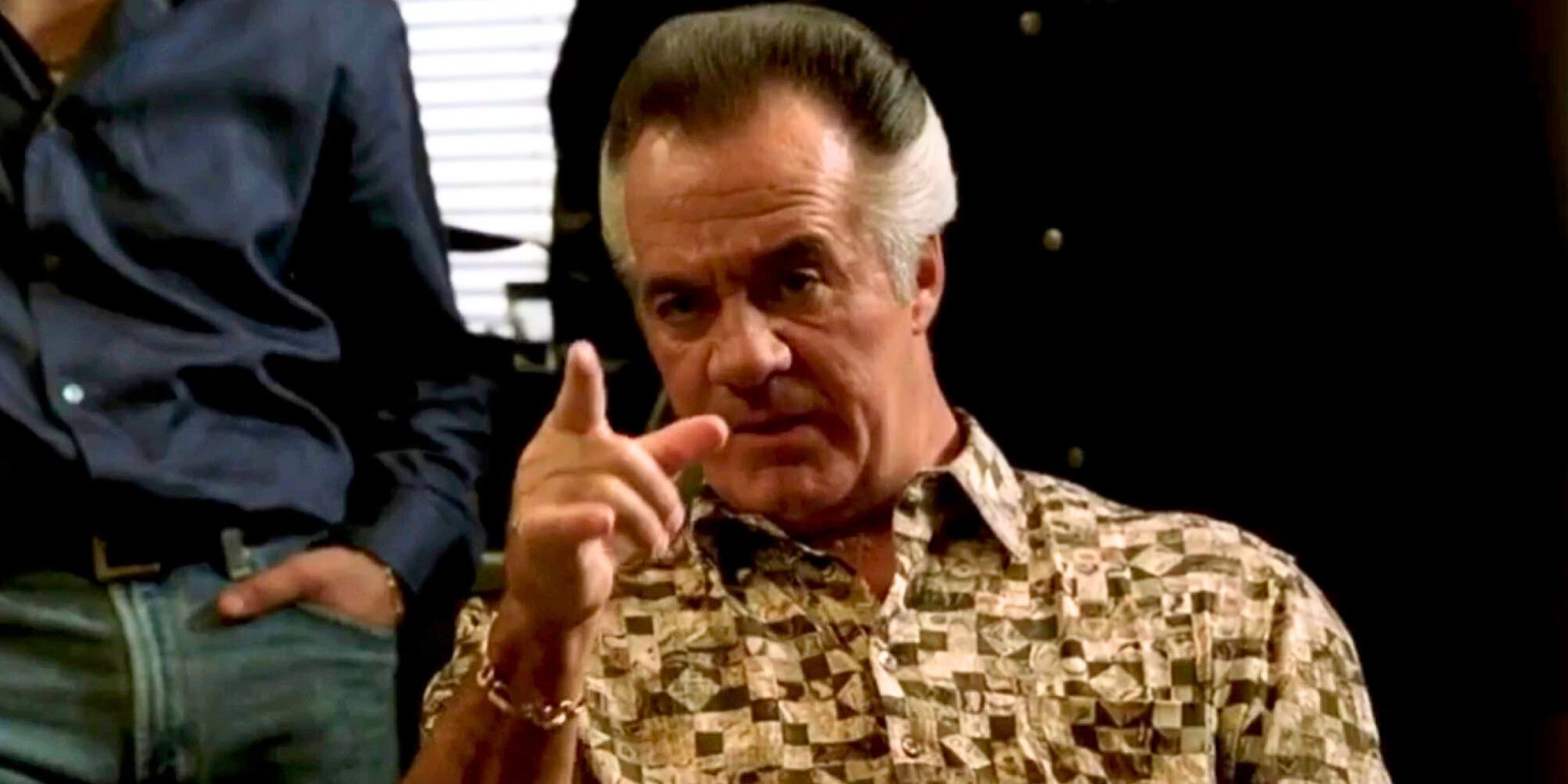 Tony Sirico as Paulie Walnuts sitting and pointing his finger at someone in The Sopranos