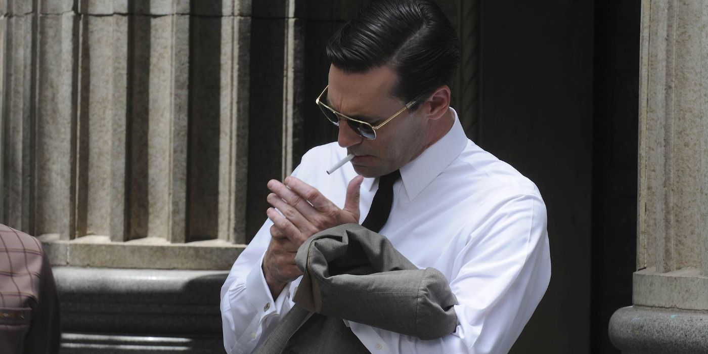 Don Draper (Jon Hamm) holds his suit jacket over his arm as he lights a cigarette in 'Mad Men' Season 4, Episode 8 "The Summer Man" (2010)