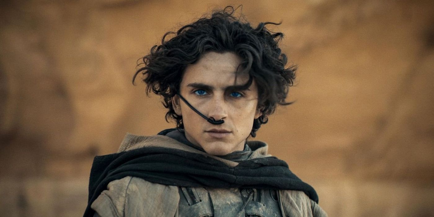 A close up still of Timothée Chalamet in the desert with an apparatus up his nose in Dune: Part Two