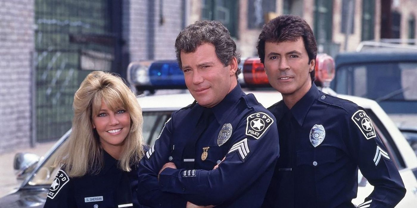 Three police officers standing together by a car in a scene from T.J. Hooker