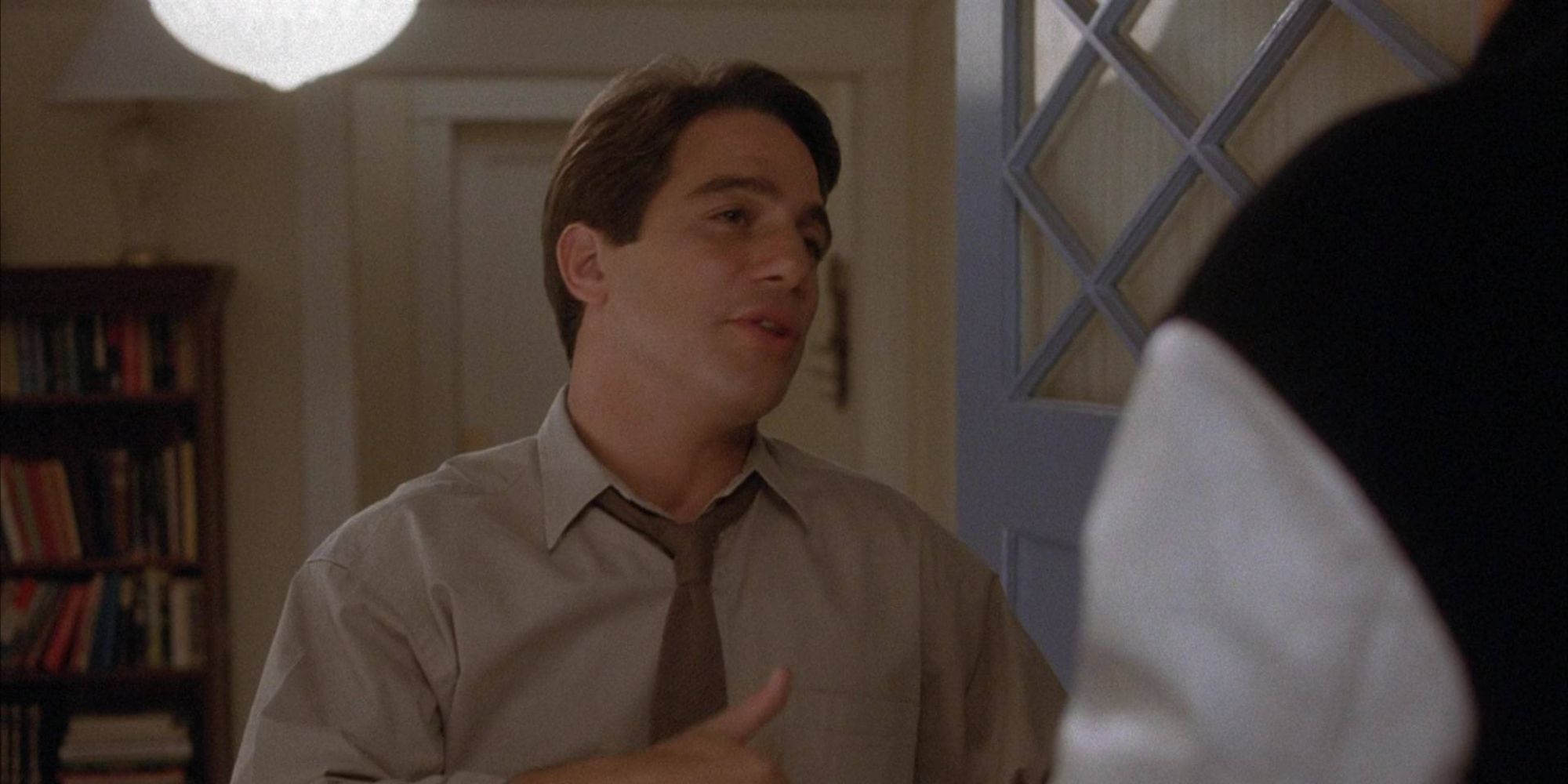 Tony Danza stands in an open doorway talking in the 1989 movie, She's Out of Control 