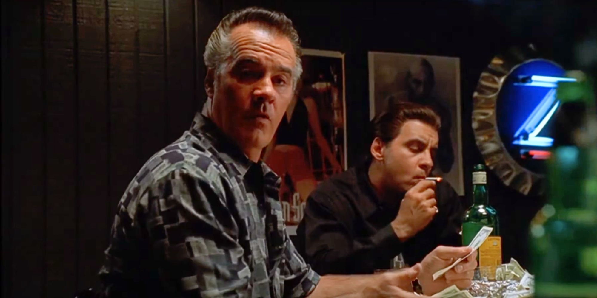 Tony Sirico sitting at a table next to Steven Van Zandt in The Sopranos