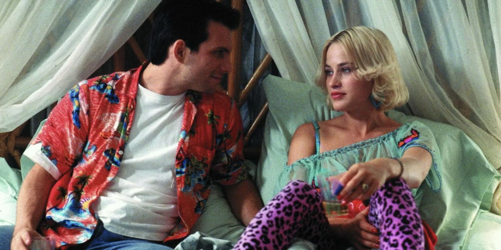 Christian Slater and Patricia Arquette sit on a bed in Tony Scott's 'True Romance'