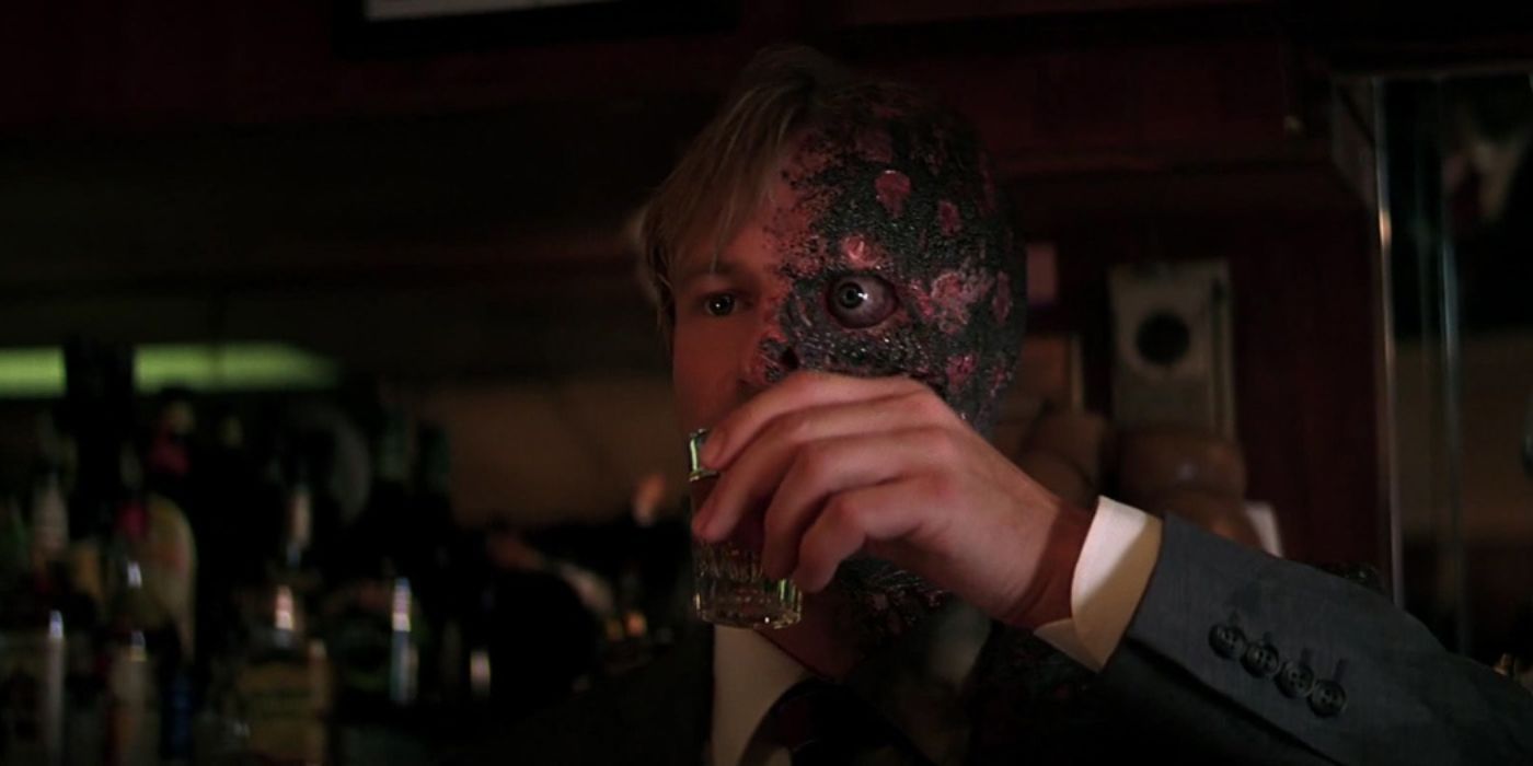 Two Face takes a shot of liquor in The Dark Knight