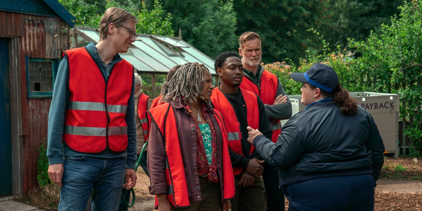 Stephen Merchant and the cast of The Outlaws Season 3 in their orange work vests 