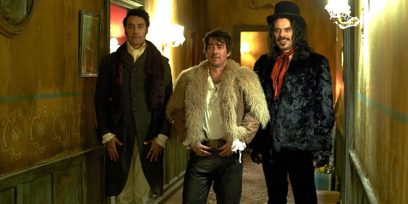 Taika Waititi, Jonathan Brugh & Jermaine Clement stand together in a hallway in What We Do in the Shadows