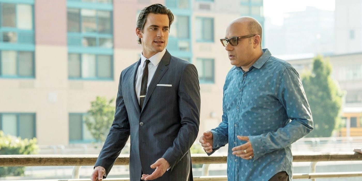 Matt Bomer and Willie Garson as Neal Caffrey and Mozzie, walking down the street and talking on White Collar