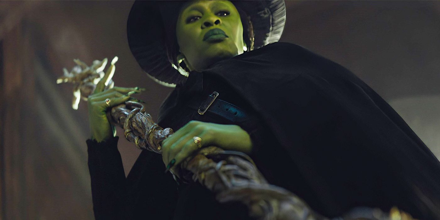 Cynthia Erivo as Elphaba clutching a staff in Wicked.
