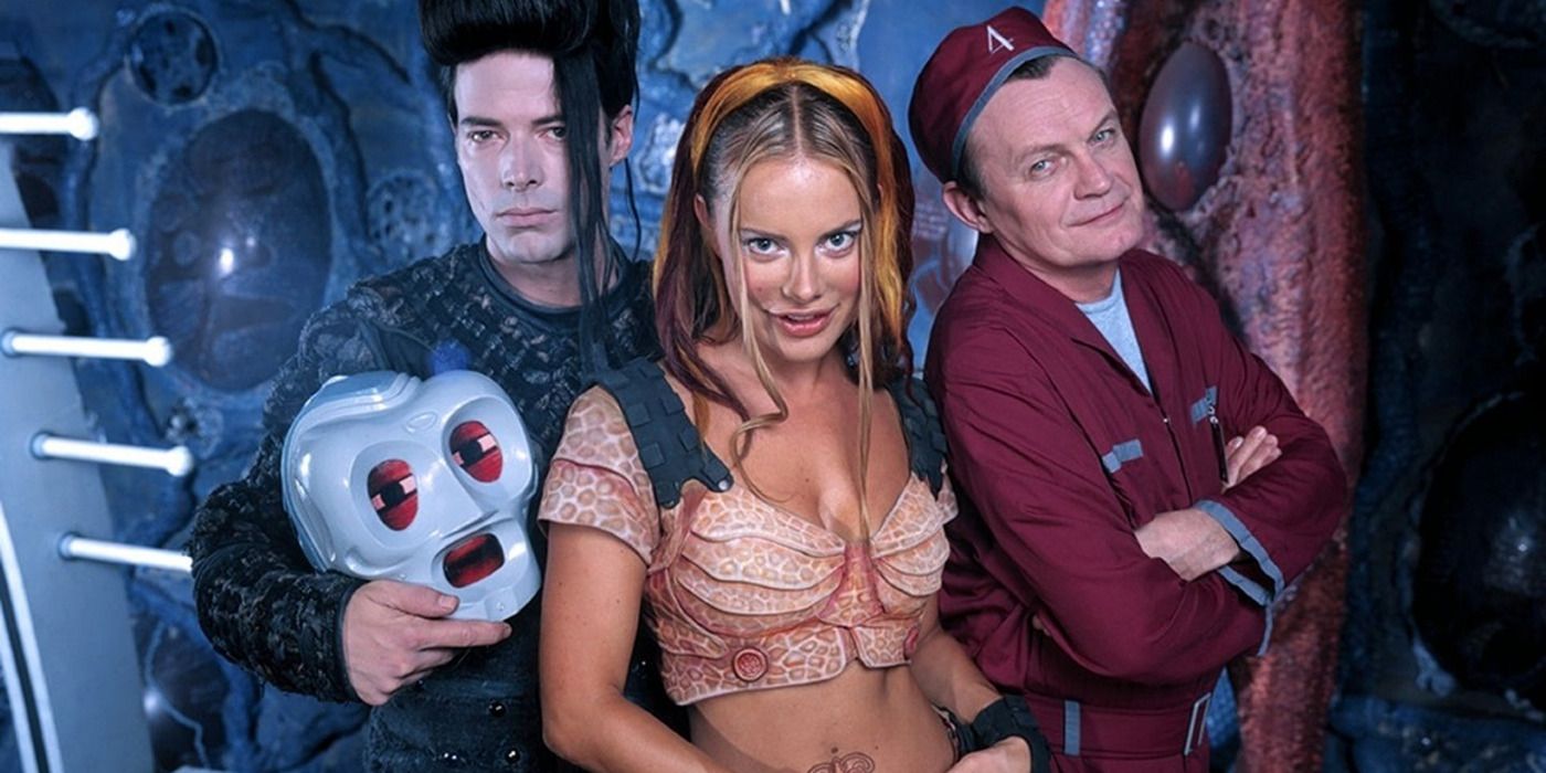 Xenia Seeberg, Michael McManus (holding a robot&rsquo;s head), and Brian Downey in sci-fi outfits in &lsquo;Lexx&rsquo;