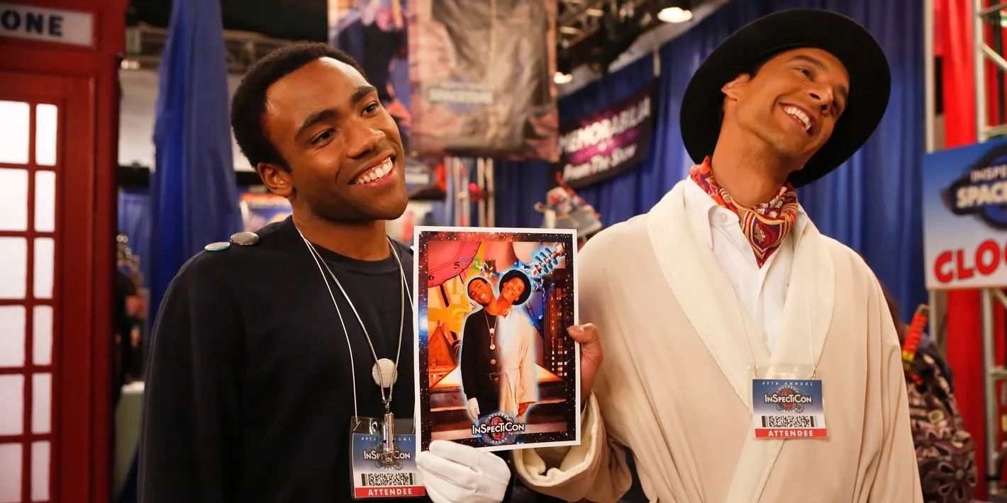 Donald Glover and Danny Pudi as Troy and Abed holding an Inspector Spacetime poster in Community