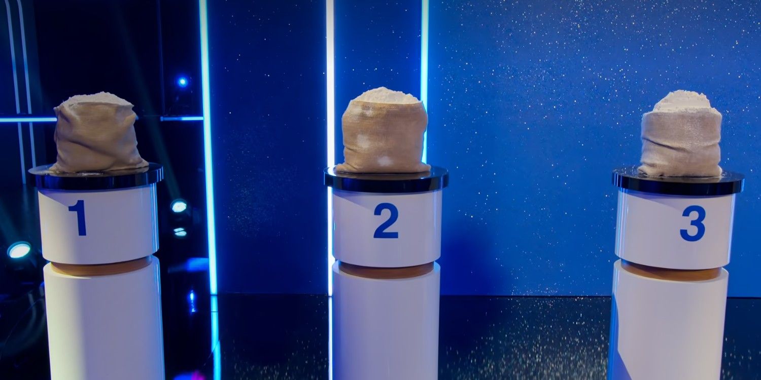 3 bags of flour - one made of cake - sit on numbered podiums on Netflix's Is It Cake