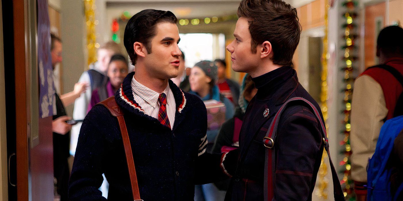 Daren Criss and Chris Colfer talking in a school hallway in Glee