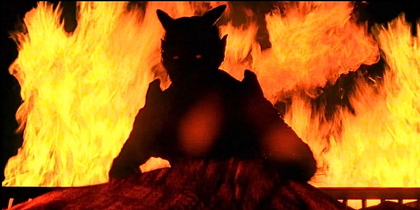 A baby-stealing demon stands at the foot of his wife's bed surrounded by flames from the episode Terms of Endearment in The X-Files