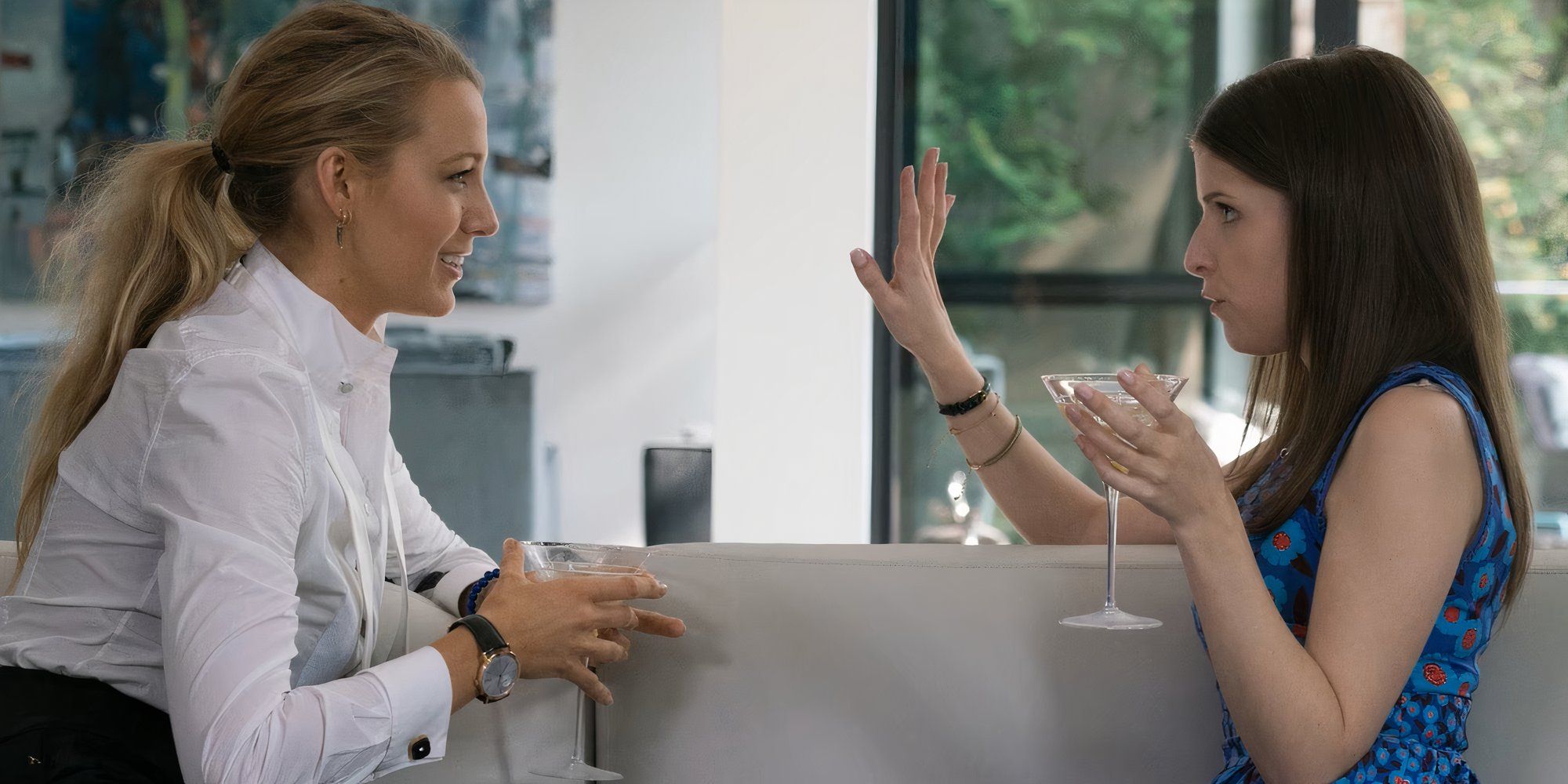 Anna Kendrick as Stephanie and Blake Lively as Emily drinking in a couch in a scene from A Simple Favor