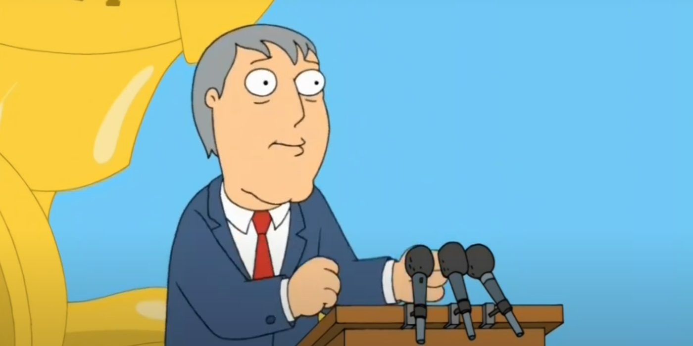 Adam West, voiced by Adam West, wearing a blue suit and red tie while speaking on a podium in Family Guy