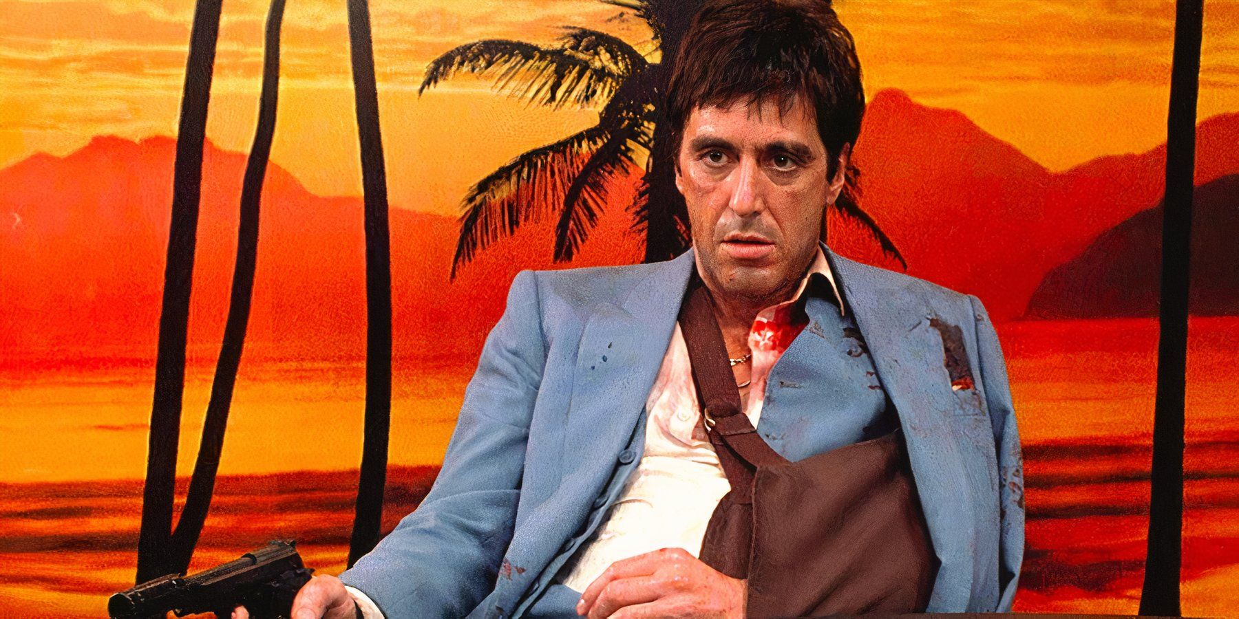 A bruised and bloody Tony Montana brandishes a gun with his arm in a sling in Scarface.