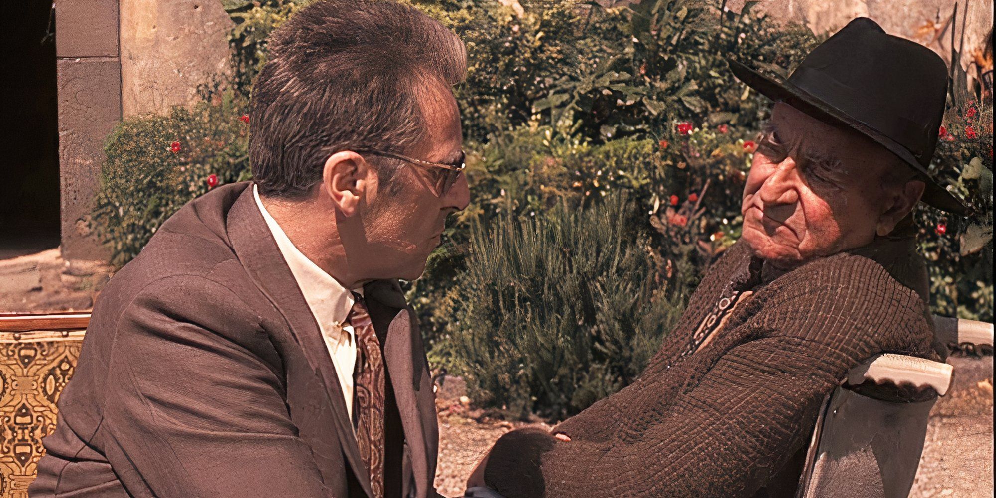 Al Pacino sitting and talking to Vittorio Duse in a wheelchair in The Godfather: Part III (1990)