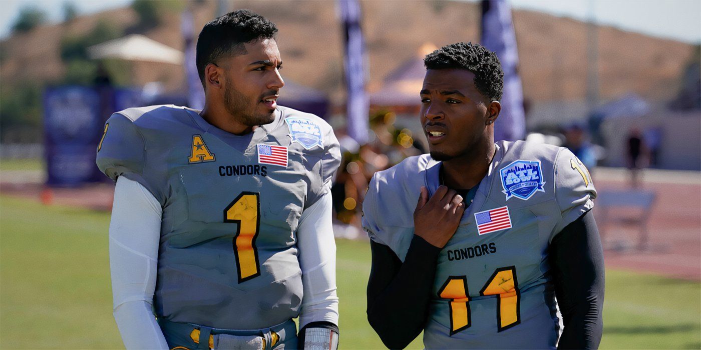 Daniel Ezra as Spencer James standing next to Michael Evans Behling as Jordan Baker in football uniform on a field in a still of All American