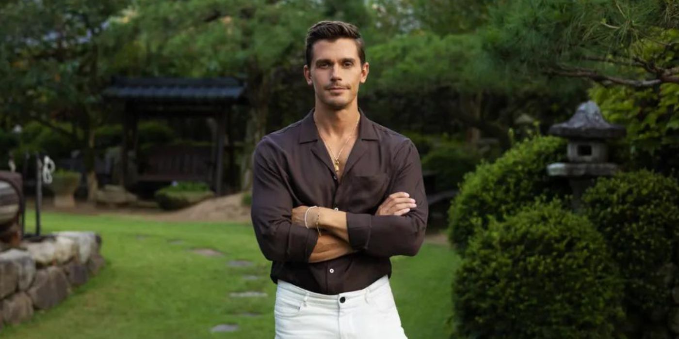 Antoni Porowski standing with arms folding in a garden for 'No Taste Like Home' promo