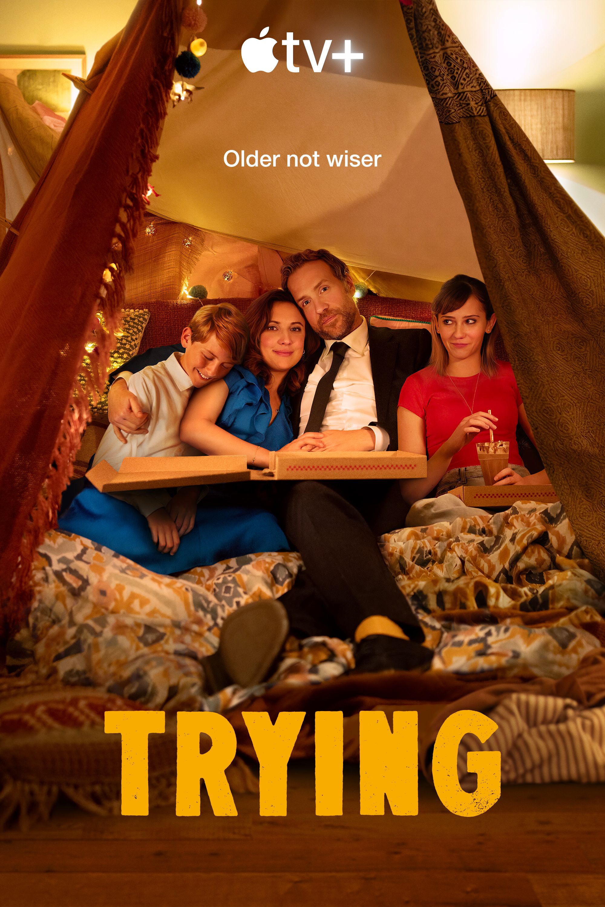 Rafe Spall and Esther Smith surrounded by two children in a tent for a promotional photo of Trying.