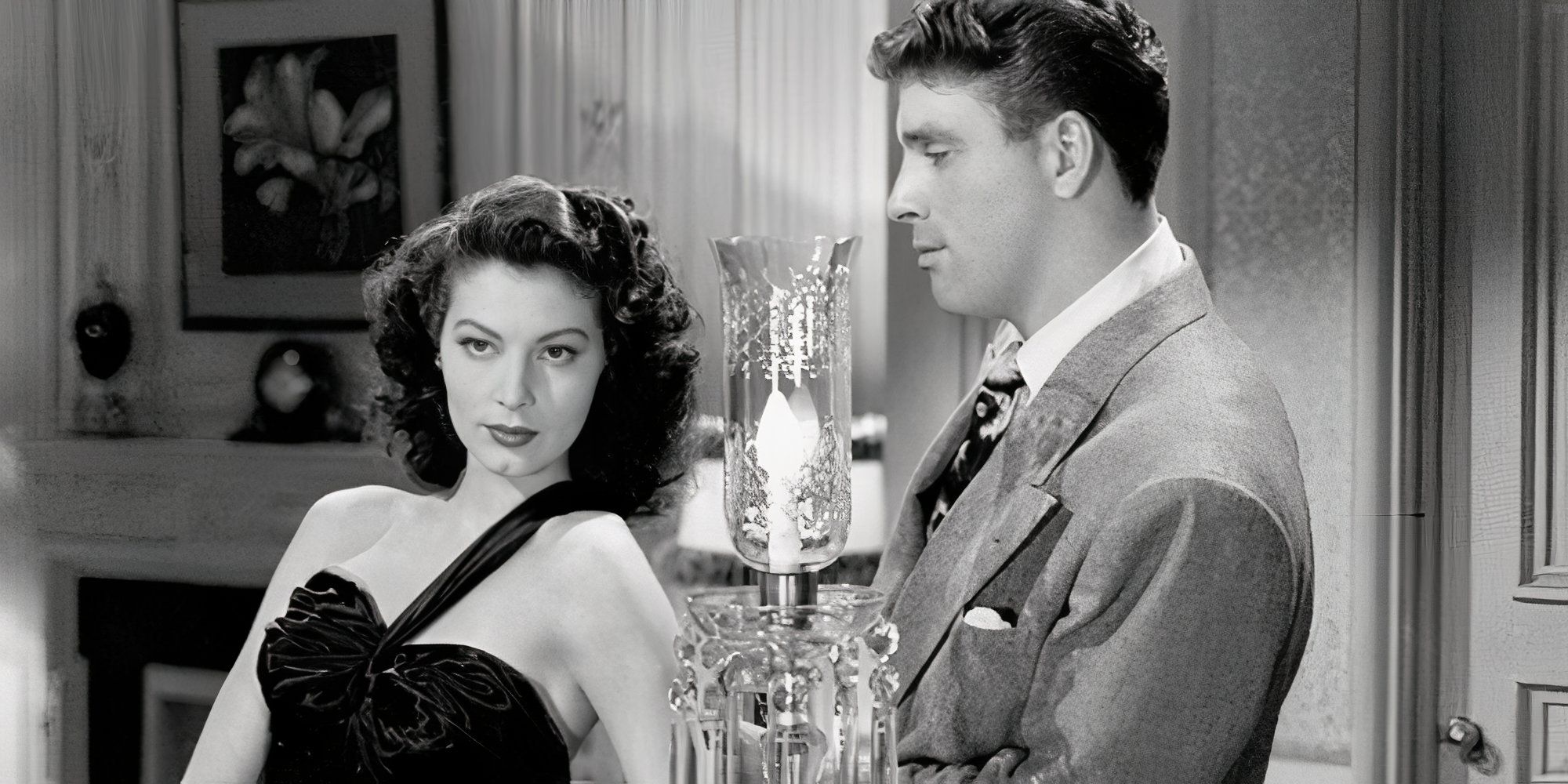 Ava Gardner leaning against a piano with Burt Lancaster standing behind her in The Killers (1946)