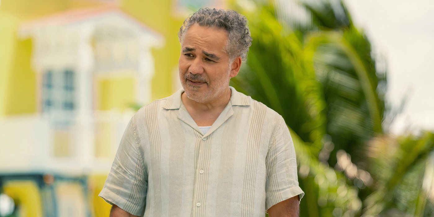 John Ortiz stands in the Florida sunshine wearing a striped shirt in ‘Bad Monkey’