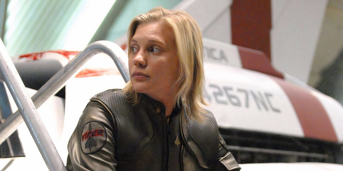 Kara (Katee Sackhoff) gazing to the left and sitting in front of a Viper ship in Battlestar Galactica