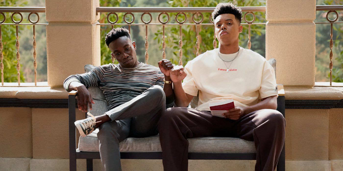 Jabari Banks and Olly Sholotan bumping fists while relaxing on a bench in Bel-Air