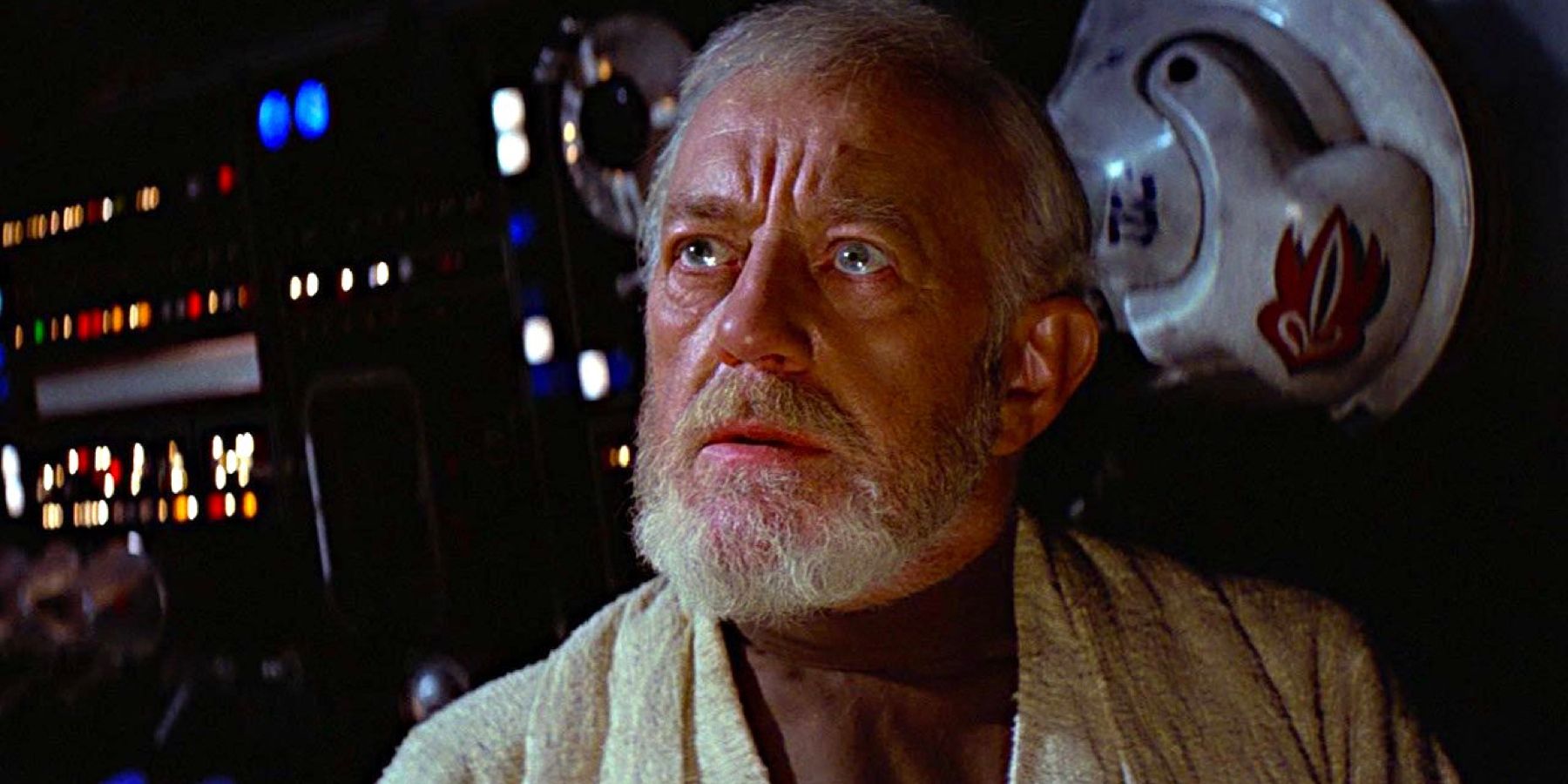 Obi-Wan Kenobi looks wary while sitting in the Millennium Falcon in Star Wars: Episode IV - A New Hope.Obi-Wan Kenobi (played by actor Sir Alec Guinness), looks wary while sitting in the Millennium Falcon in Star Wars: Episode IV - A New Hope.