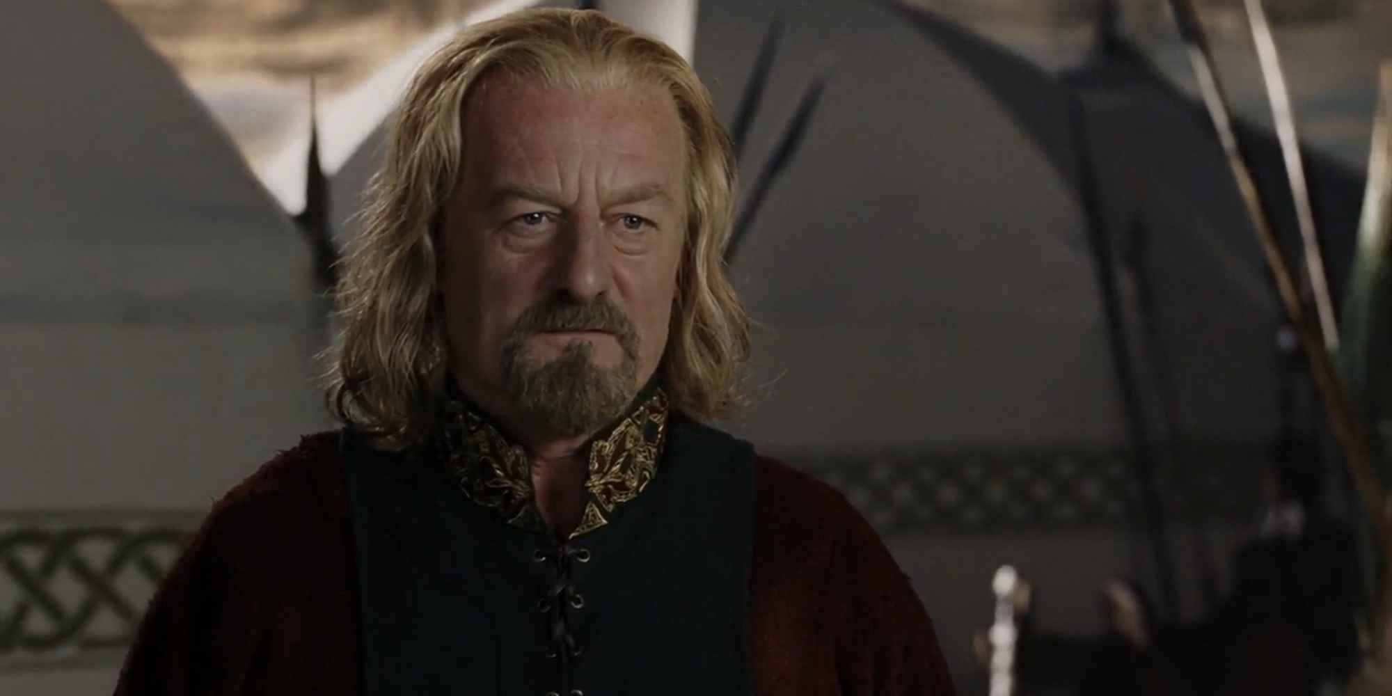 Bernard Hill as Theoden, standing in front of tents during sunrise.