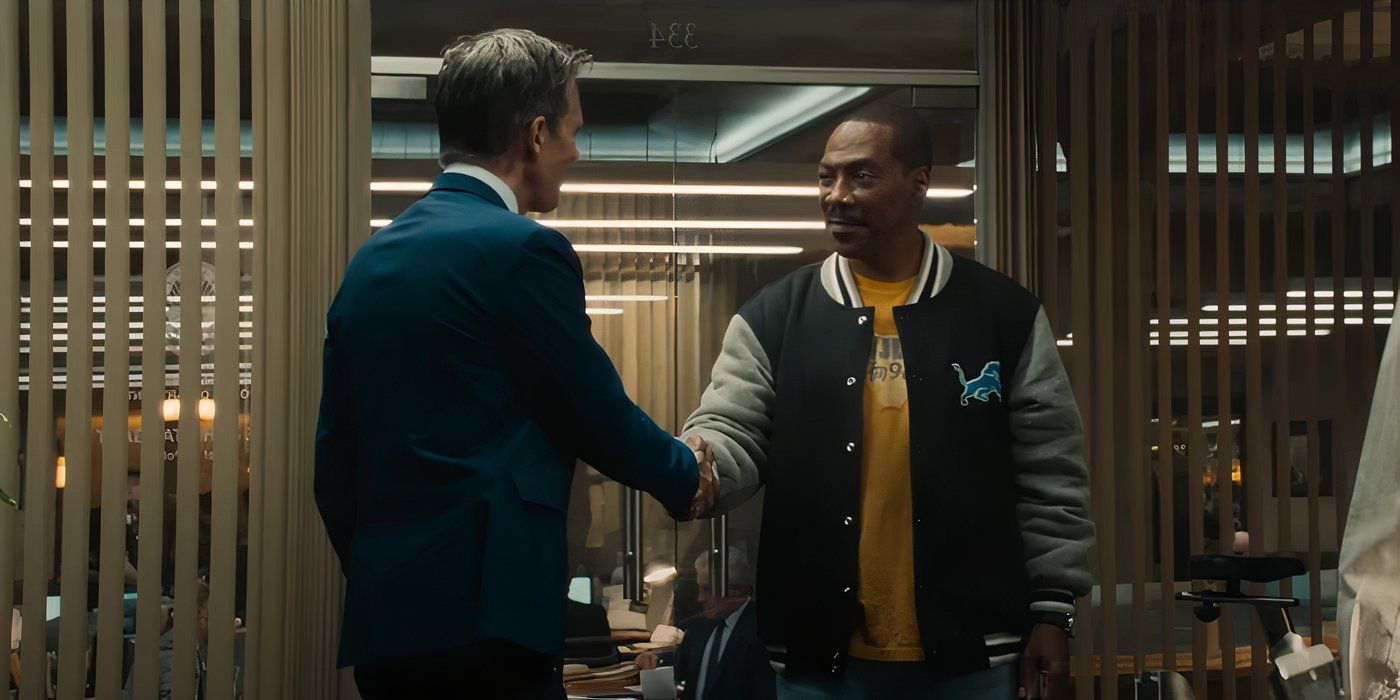 Eddie Murphy shaking Kevin Bacon's hand in a police station.