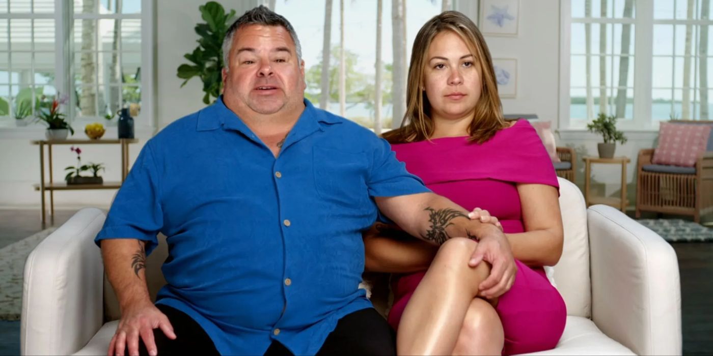 Big Ed Brown from 90 Day Fiance with his hand draped over Liz Woods' leg on a white couch.