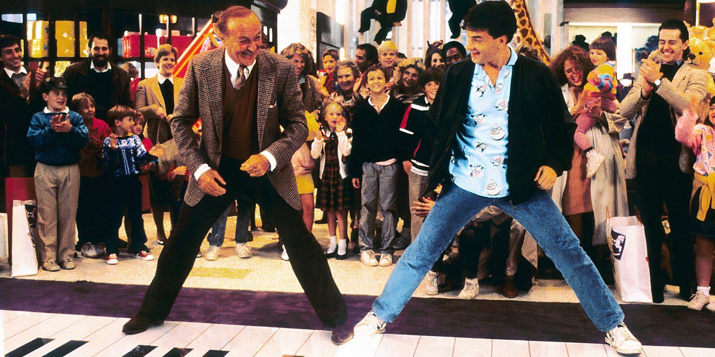 Two men laughing while spreading their feet on a giant piano in the movie Big.