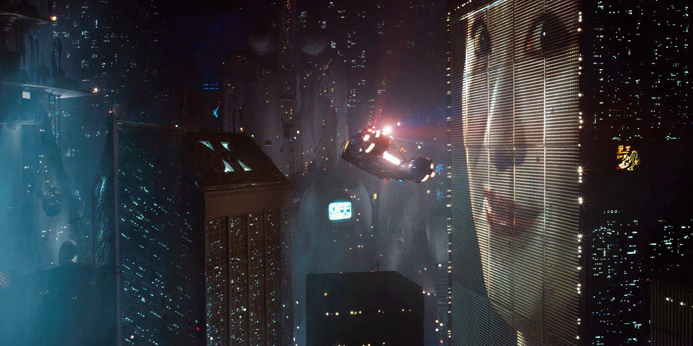A large face projected on a skyscrapper in a futuristic city in Blade Runner
