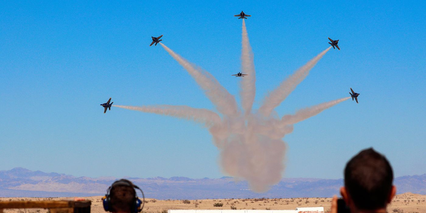 Six Blue angel Jets flying over the desert, leaving behind trails of smoke