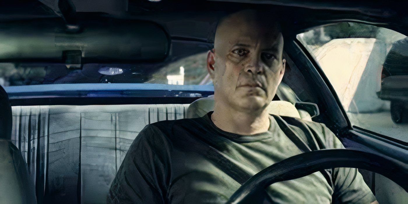 A bald Vince Vaughn sits in the driver's seat of a car looking serious in Brawl in Cell Block 99.