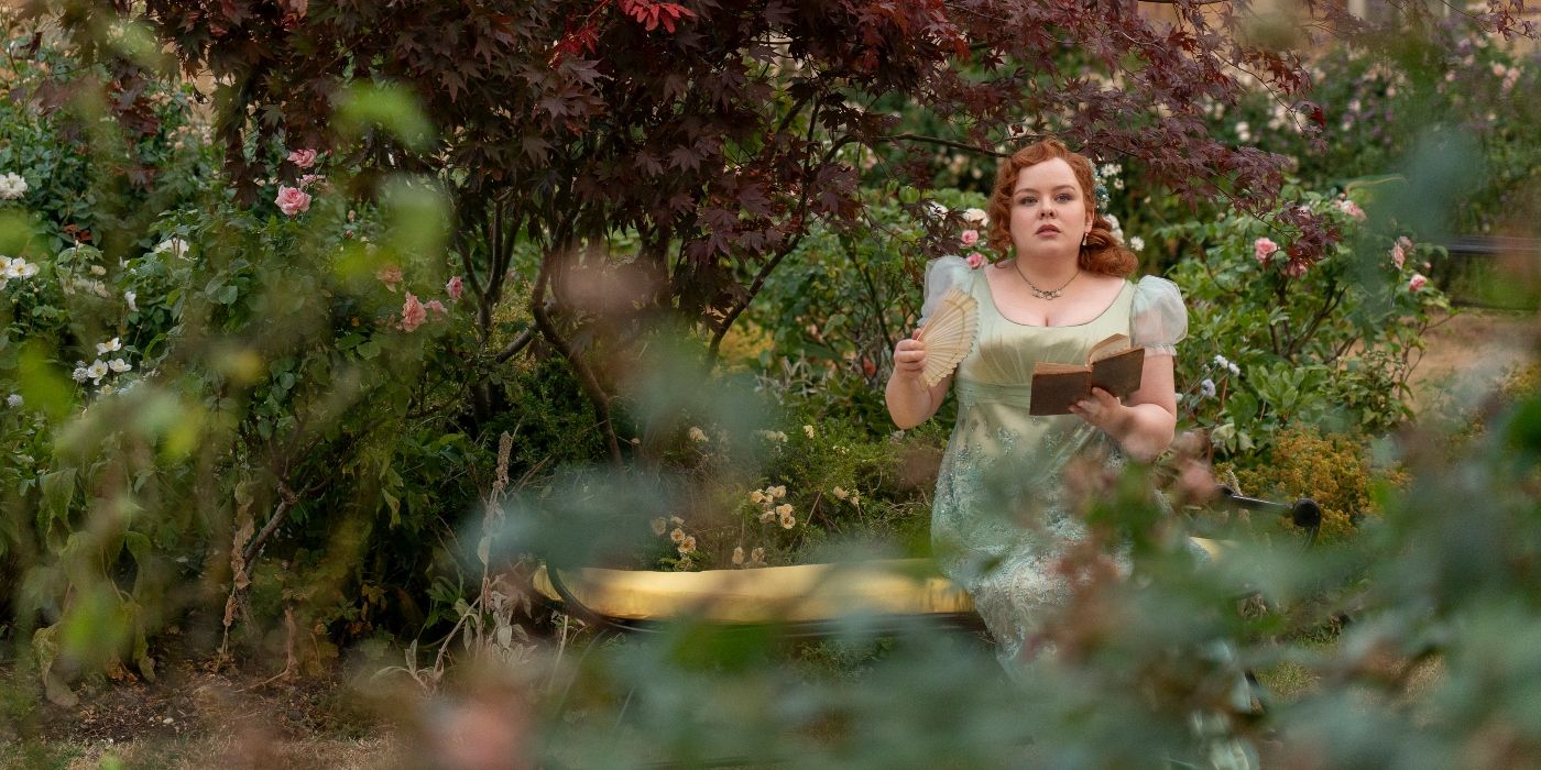 Nicola Coughlan sitting on a garden bench in Bridgerton Season 3 Episode 1