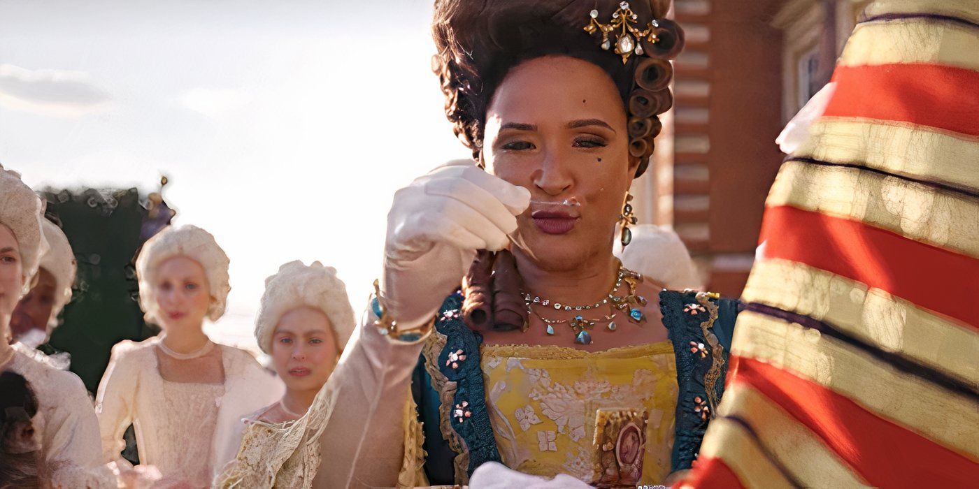 Queen Charlotte, holding snuff on a spoon while women in white wigs and dresses stand behind her in Bridgerton