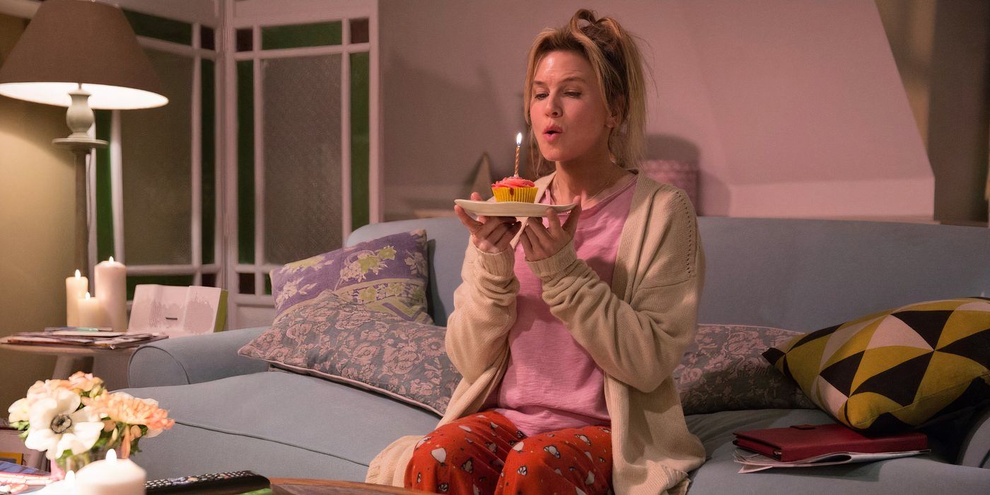 Renée Zellweger's Bridget Jones blowing at a candle on a pink-frosted cupcake.