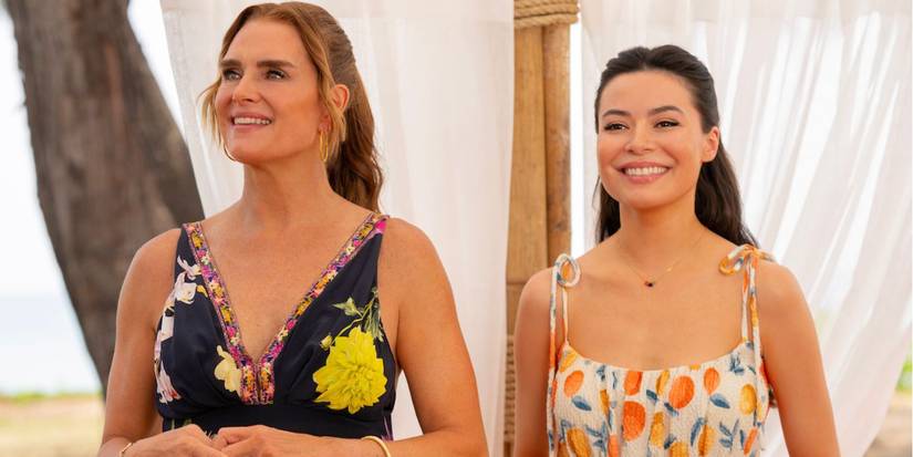 Brooke Shields standing next to Miranda Cosgrove, wearing summer dresses on the beach in a scene from 'Mother of the Bride'