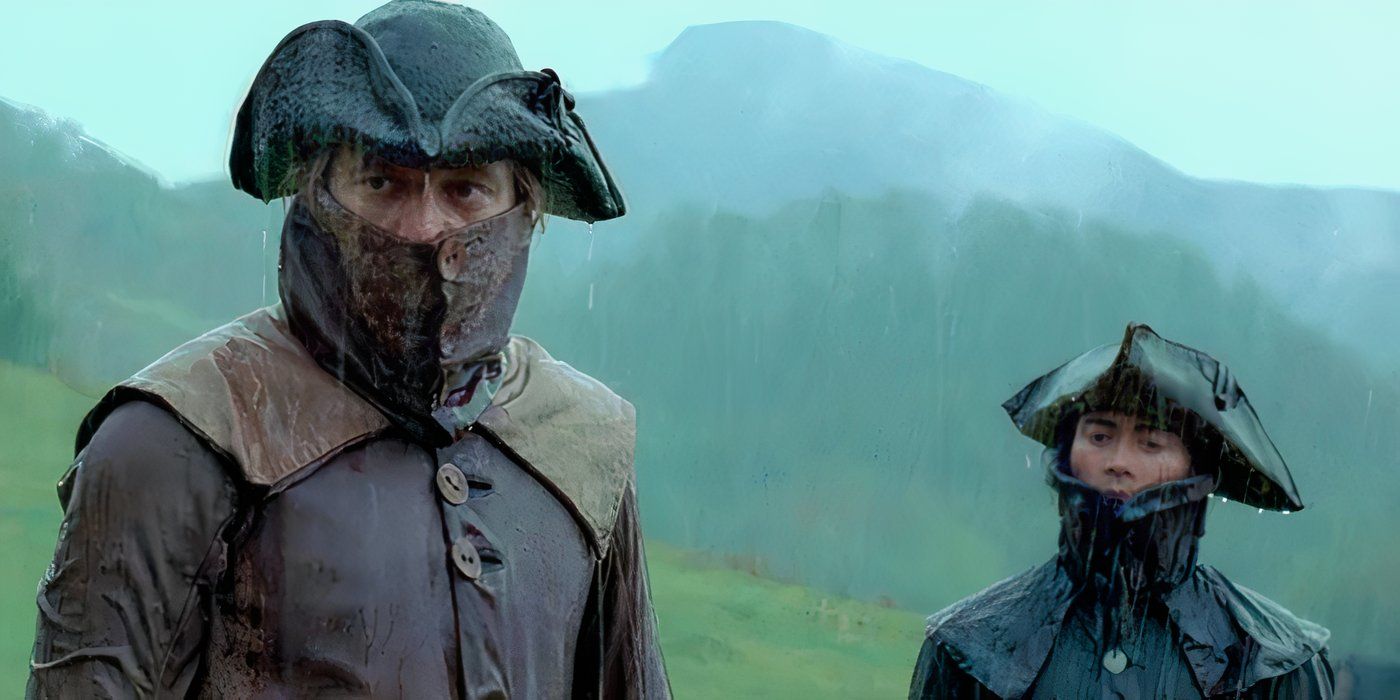 Two men stand side by side in the rain. Both are wearing tricorn hats and cloths over their faces