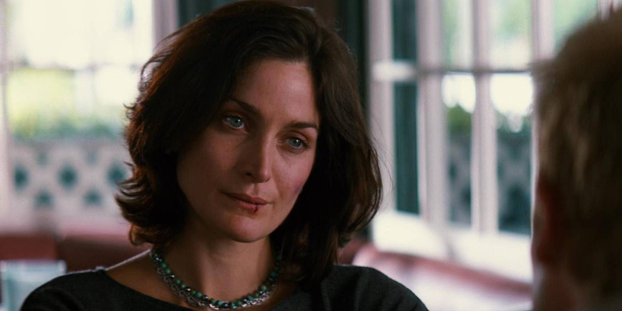 Carrie-Anne Moss in Memento as Natalie with a cut on her lip