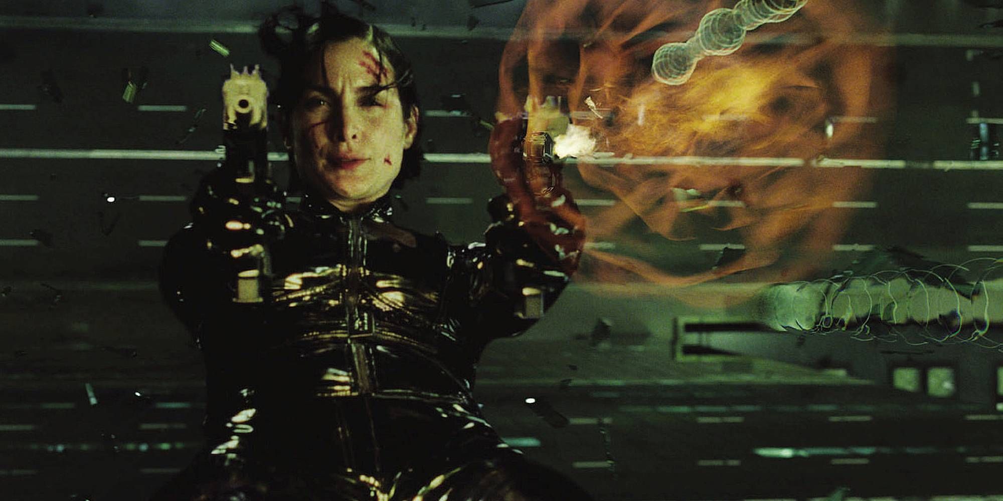 Carrie-Anne Moss in The Matrix Reloaded as Trinity shooting a gun
