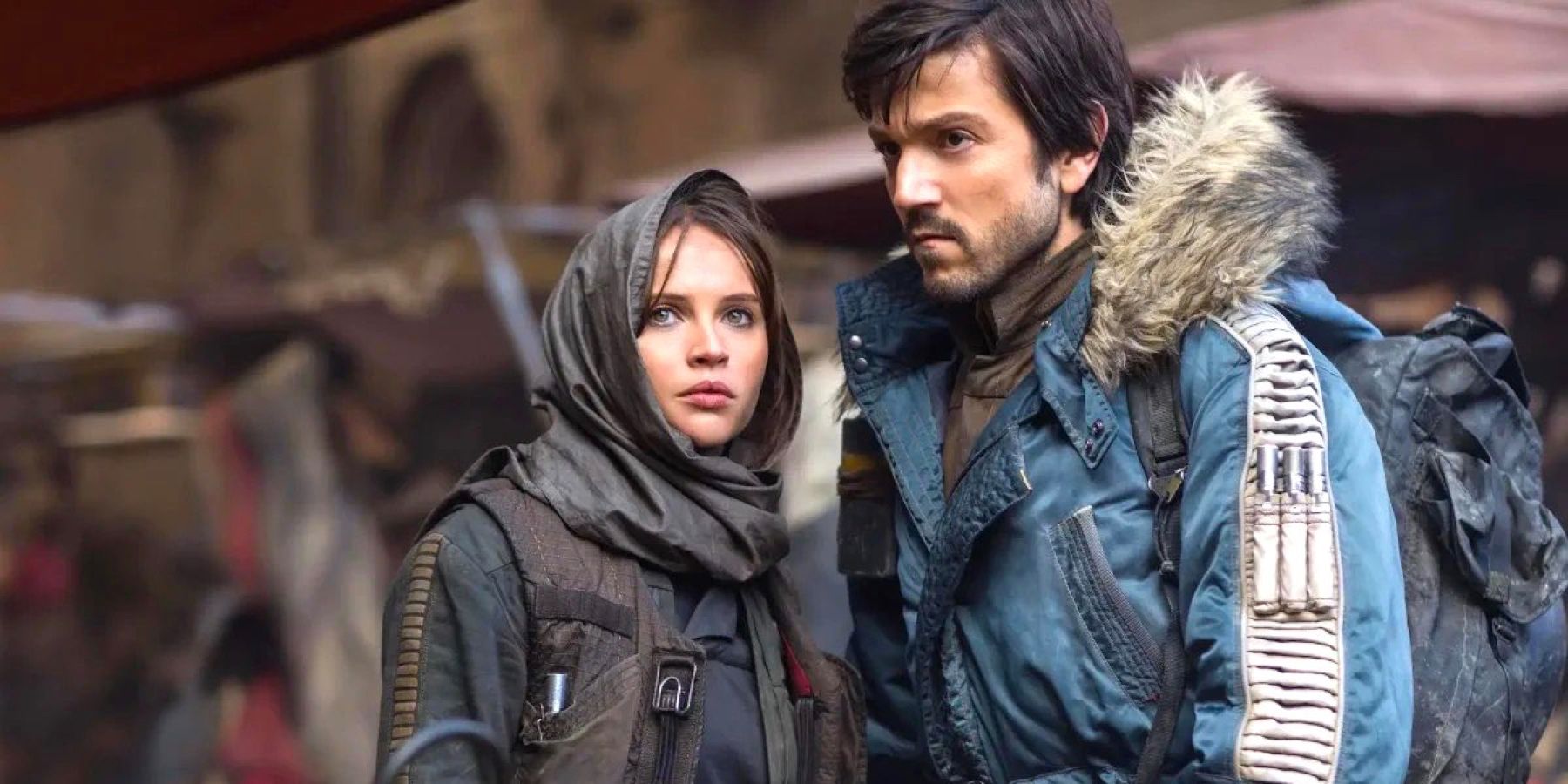 Cassian Andor and Jon Erso lay low in a market on the planet Jedha in Rogue One: A Star Wars Story.