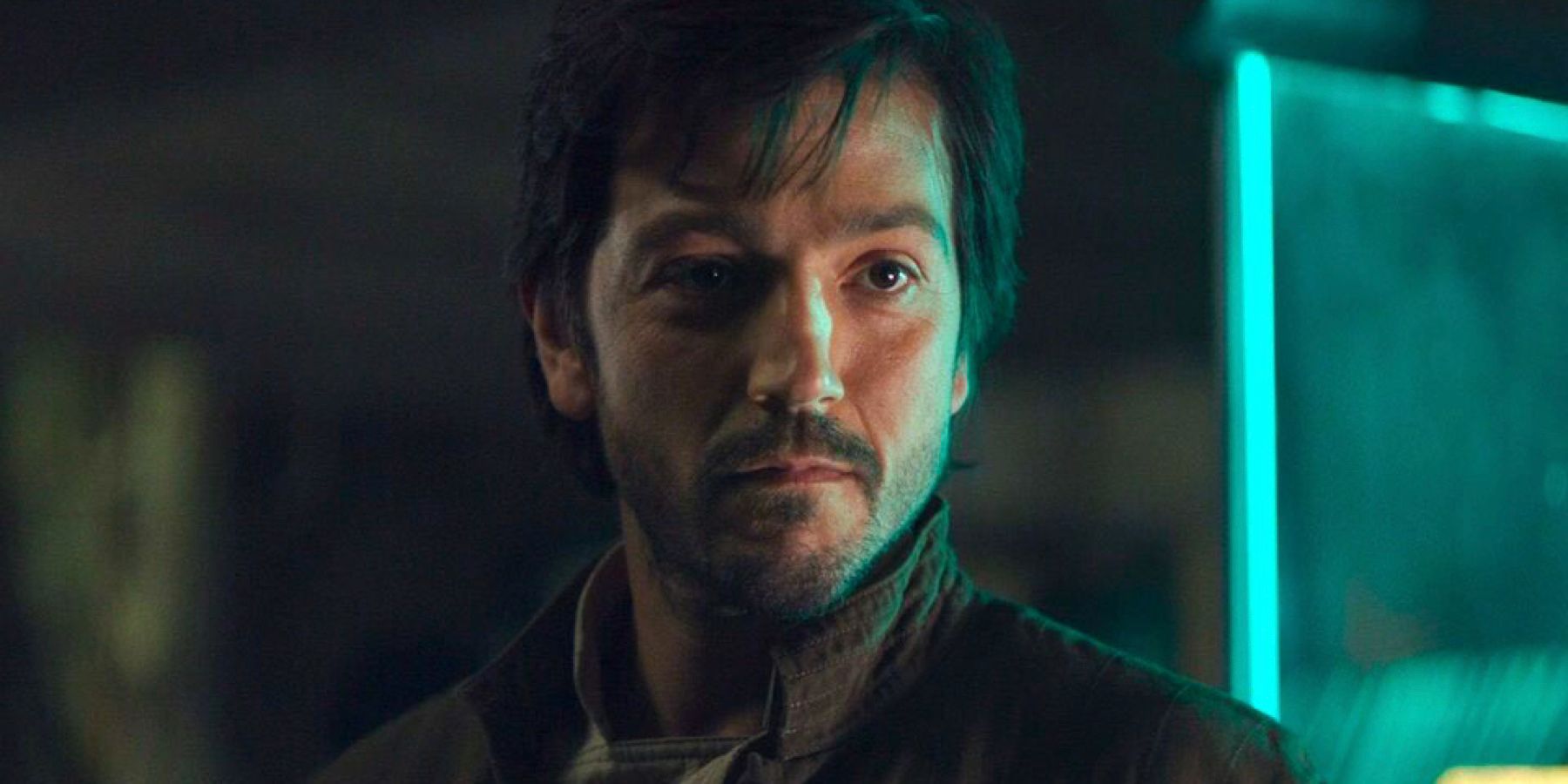 Cassian Andor smirks inside the Rebel Base on Yavin 4 in Rogue One: A Star Wars Story.